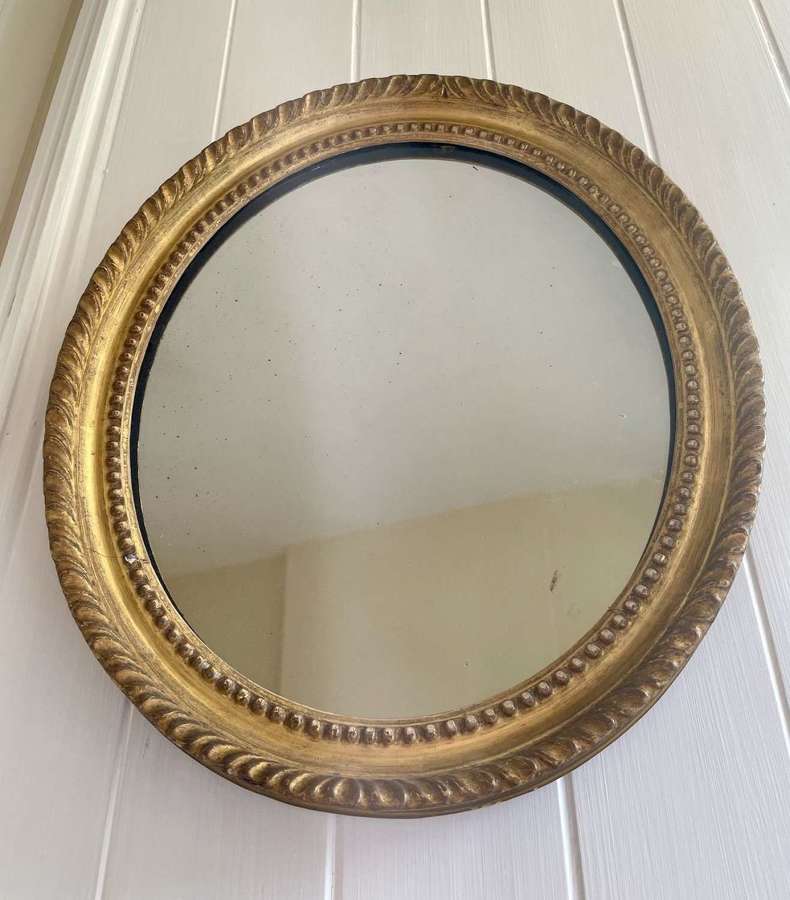 A Regency oval mirror