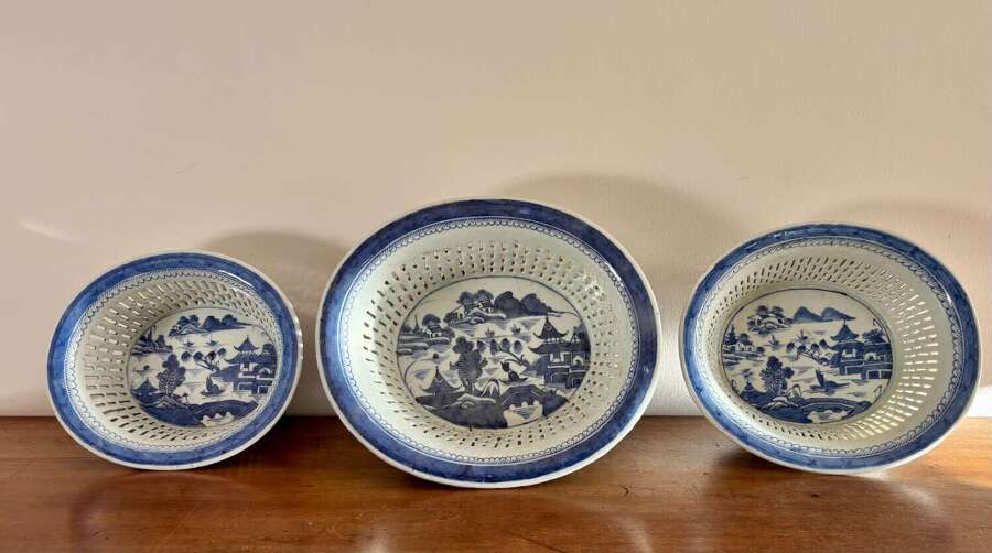 A set of three Chinese baskets and stands