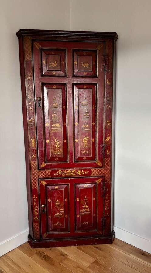 A George III red lacquer corner cabinet